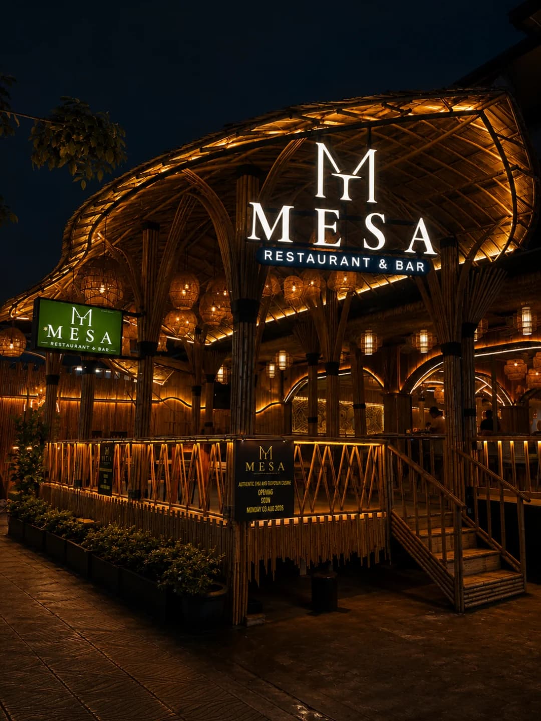 The lit MESA sign over the bamboo pavilion at night